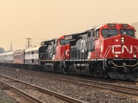 CN 3319 and 3412 lead CN’s Office Car Special (OCS) train through CN London East, while the city was shrouded in smoke and ash from wildfires in northwestern Ontario.
