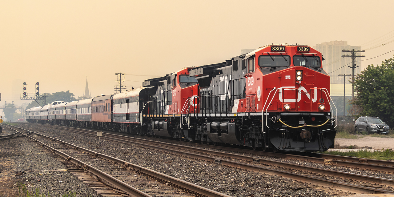 CN 3319 and 3412 lead CN’s Office Car Special (OCS) train through CN London East, while the city was shrouded in smoke and ash from wildfires in northwestern Ontario.