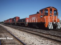 During the summer of 1996, Dow Chemical sent SW1200 1007 from their Fort Saskatchewan facility to their plant in Sarnia, Ontario. At the time, in return Dow transferred S-6 1001 from Sarnia to Fort Saskatchewan after only being in Sarnia since arriving in 1993. Eventually Dow closed their Sarina plant, and it was torn down with SW1200 1007 eventually being acquired by VIP Rail in Sarnia.
<br>
Here 1007 is pictured on route to its new home on train 399 at London. The consist included; 9504, GTW 6410, 5013, 9582, 7208, 218 and DOW 1007. 
