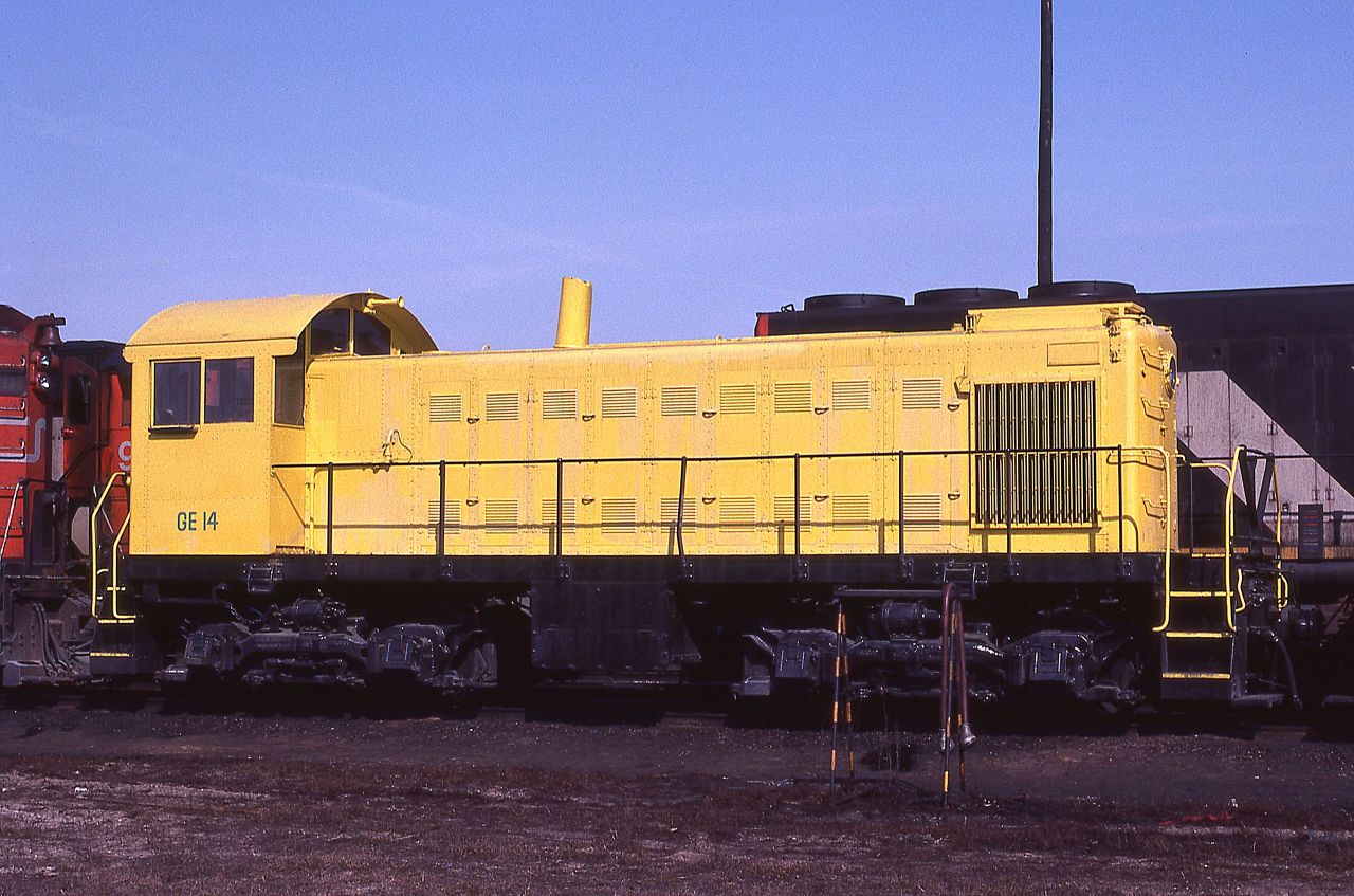 Just passing through!!! General Electric Alco S-1 switcher # 14 is shown at CN's MacMillan Yard in Vaughan, Ontario on March 18, 1979.  The unit is a former Maine Central locomotive that was traded in to GE on MEC's U18s.  The former MEC unit could be either 955 or 956 as both apparently were renumbered to GE 14.