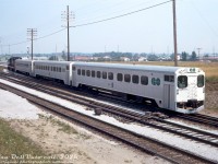 A short train of GO Transit single-level Hawker Siddeley cars ("GO Karts") pulls out of the commuter lead at Pickering GO Station, heading westbound on the CN Kingston Sub in Lakeshore line service. GO cab car 9855 leads two other cars, with GP40TC 9807 pushing on the tail end (locomotive view <a href=http://www.railpictures.ca/?attachment_id=50253><b>here</b></a>).<br><br><i>Original photographer unknown (possibly a John H. Eagle photo), Dan Dell'Unto collection slide.</i>