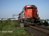 During a spring evening, GTW SD40-2 5936 and GP40-2L(W) 9575 lead a westbound CN intermodal train through Milton, Ontario at Milbase on the Halton Subdivision. 