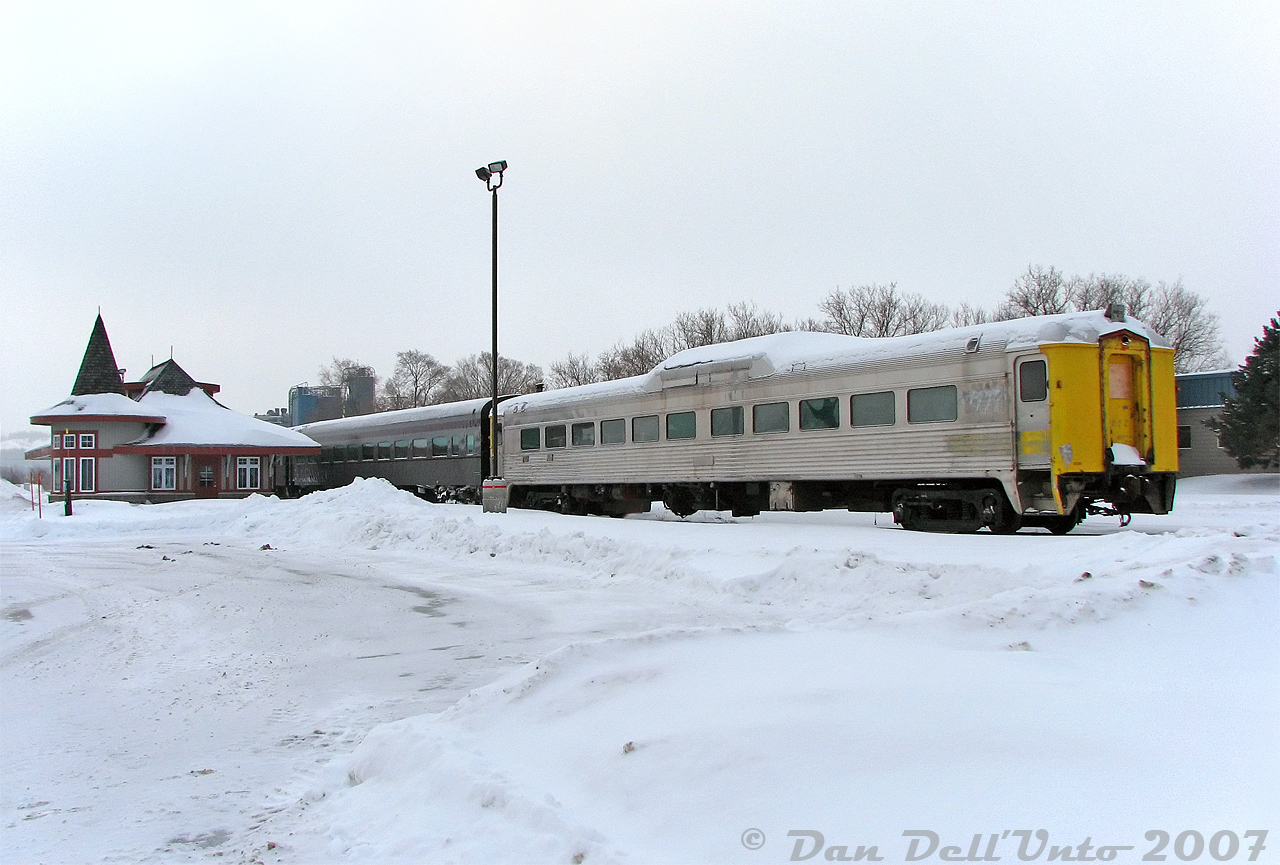 Orangeville-Brampton Railway's former VIA Rail RDC-9 6006 sits on the station track at OBRY's Orangeville Yard, coupled to the other three Credit Valley Explorer passenger cars next to the "new" Orangeville Station on a snowy, cold morning. 

After picking up a friend in Fergus, we headed to Orangeville with hopes of the OBRY running (driftbusting!?) due to recent snowfall activity. Unfortunately, the front of CCGX 1000 was packed with snow, suggesting it had run the previous day. It was pretty much dead there that morning (not unlike Orangeville today, just with more train stuff sitting around), so we settled for some photos of the equipment and station before departing for Guelph.

This rare cabless Budd RDC-9 specimen was one of only 30 built, all for the Boston & Maine RR in 1956. CN scooped up seven in 1965 (6000-6006), that were later passed off to VIA. When VIA retired them in the 1980's, they were stored and most later sold off to dealer David A. Walmsley (this one becoming DAWX 6006). 6006 was sold to Ontario Rail Equipment Leasing (ORXX) in 2006, whose owner was involved with operating the Credit Valley Explorer. It was stored out of use on the OBRY, and photos suggest it may have run as a trailing car on the CVE a few times (with end-mounted lights). It was later sold to the Waterloo Central Railway around when CVE operations ended, coinciding with operation of the OBRY changing from Cando to GIO Rail in 2018.