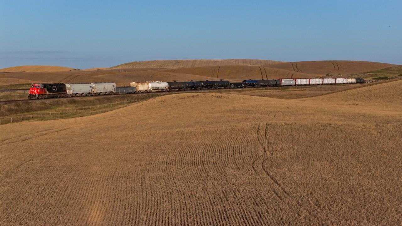 CN 8340 grinds upgrade towards Biggar with the daily Winnipeg to Mirror, Alberta manifest.