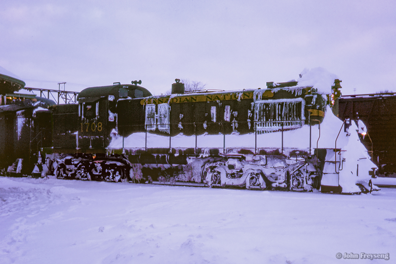 CN train 674 from Southampton arrives at Palmerston with conventional passenger equipment trailing RSC13 1708. While typically equipped with RDCs, conventional equipment would return to the branchlines during the Christmas season, while the Budd cars were added to Niagara-bound trains. Several UCRS members made the trip to Palmerston on Boxing Day, 1962, to ride the wayfreight to Kincardine. The train, which ran as an extra, was not using a van for the tailend crew due to a shortage, but rather an old combine, giving the train the appearance of a mixed train. Regular passenger service on the Kincardine Sub still remained in 1962 in the form of one RDC trip. With releases signed, UCRS members were permitted to ride the "mixed," and with two at a time permitted to ride the flanger which departed for Listowel behind a pair of MLW RSC-13s; 1709 and 1732.Further details can be found in the February 1963 UCRS newsletter.

672 arrives from Owen Sound
Later that day, Extra CNR 1732 at Brussels

Scan and editing by Jacob Patterson.