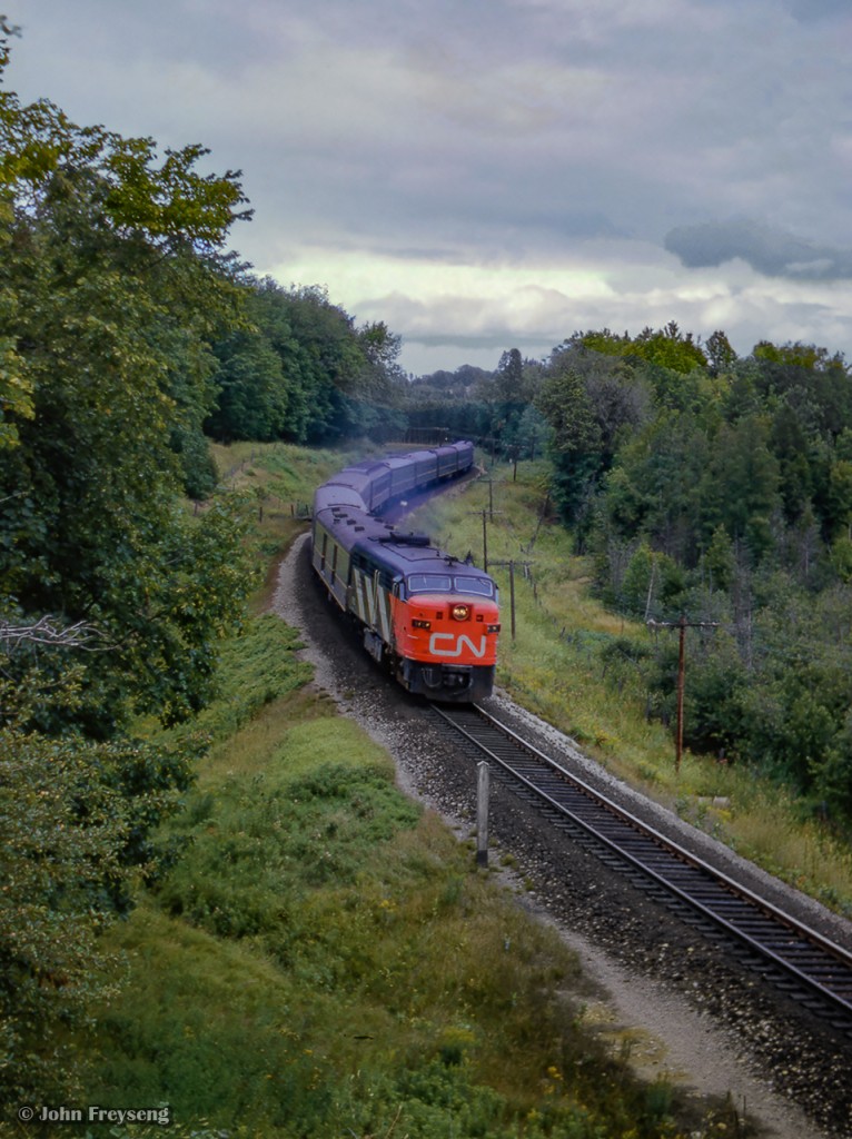The day after shooting Friday only train 43 northbound near Mount Albert, John is back in the S-curves shooting the equipment returning south as Saturday only train 56, North Bay - Toronto via  Beaverton.  These train are listed as summer only, operating June June 25 through September 5 for the 1964 season.

Earlier that morning:
Train 52 departing Washago
52 meets 409


Scan and editing by Jacob Patterson.