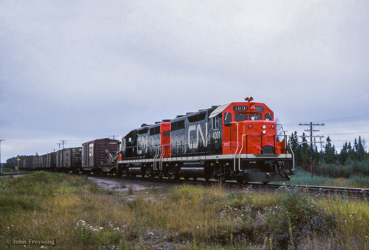 Canadian National's only two GP35 units, recently released from GMD London, lead a westbound train over the diamond with the Algoma Central at Oba, meeting southbound ACR train 2, out of view at left.Pausing at the stationThe head endThe ACR/CN meetScan and editing by Jacob Patterson.