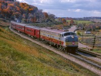 The weekend of October 23 & 24, 1965 saw the Upper Canada Railway Society run an excursion on each of the class one railways. The Saturday trip running on the Canadian Pacific behind CPR E8A 1802 departed Toronto Union station for Hamilton's TH&B Hunter Street station via the Oakville Sub, before heading up to Guelph Junction, Streetsville, and north to Orangeville before returning to Union Station. Here, the train snakes through the curves near the former station site of Christie, just east of the Kelso ski hill.<br><br>More of this excursion:<br><a href=https://www.railpictures.ca/?attachment_id=52063>Southbound at Cataract</a><br><a href=https://www.railpictures.ca/?attachment_id=57618>Southbound at Inglewood</a><br><br><i>Scan and editing by Jacob Patterson.</i>
