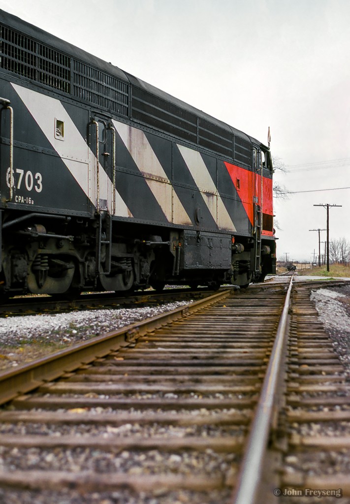 The weekend of October 23 & 24, 1965 saw the Upper Canada Railway Society run an excursion on each of the class one railways. The Sunday trip running on the Canadian National behind CNR CPA-16-5 6704 and FPA-4 6774 departed Toronto Union station for Georgetown via the Weston and Halton Subs, before heading up to Allandale along the Beeton Sub returning to Union Station via the Newmarket. Here, the train passes over the diamond at Inglewood.  Note the gondola in the distance, spotted on a CPR siding.

More of this excursion:
Approaching Inglewood
Tottenham pond

Scan and editing by Jacob Patterson.