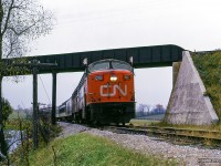The weekend of October 23 & 24, 1965 saw the Upper Canada Railway Society run an excursion on each of the class one railways. The Sunday trip running on the Canadian National behind CNR CPA-16-5 6704 and FPA-4 6774 departed Toronto Union station for Georgetown via the Weston and Halton Subs, before heading up to Allandale along the Beeton Sub returning to Union Station via the Newmarket. Here, the train passes beneath CPR's Mactier Sub just south of Beeton.

<br><br>More of this excursion:
<br><a href=https://www.railpictures.ca/?attachment_id=58467>Approaching Inglewood</a>
<br><a href=https://www.railpictures.ca/?attachment_id=60003>Inglewood diamond</a>
<br><a href=https://www.railpictures.ca/?attachment_id=55179>Tottenham pond</a>

<br><br><i>Scan and editing by Jacob Patterson.</i>