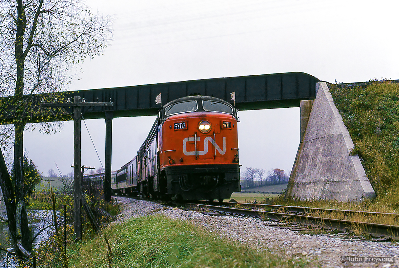 The weekend of October 23 & 24, 1965 saw the Upper Canada Railway Society run an excursion on each of the class one railways. The Sunday trip running on the Canadian National behind CNR CPA-16-5 6704 and FPA-4 6774 departed Toronto Union station for Georgetown via the Weston and Halton Subs, before heading up to Allandale along the Beeton Sub returning to Union Station via the Newmarket. Here, the train passes beneath CPR's Mactier Sub just south of Beeton.

More of this excursion:
Approaching Inglewood
Inglewood diamond
Tottenham pond

Scan and editing by Jacob Patterson.