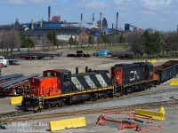 Steel: Before Tariffs, and that big orange oaf, steel was being shipped everywhere out of Hamilton, and pictured are two CN classics shoving a gondola into  the former Stelco Bar Mill now known as MANA, and in the background, is the still standing Stelco Blast furnaces. Today, MANA doesn't seem anywhere near as busy. Stelco of course has basically been razed to the ground save for the coke works, but the blast furnaces and half the buildings are gone.<br><br>Oh to do this again. We had it great in 2020. CN had just taken back a few branchlines and industrial railways in Ontario, and they put <a href=http://www.railpictures.ca/?attachment_id=33879 target=_blank> all kinds of junk into service on the mainline </a> (Tim Stevens), as well on the branchlines - the GMD-1's were part of that  <a href=http://www.railpictures.ca/?attachment_id=38519 target=_blank>junk they re-activated in 2018/9</a> and used only until March/April 2021 - <a href=http://www.railpictures.ca/?attachment_id=45278 target=_blank>the last in revenue freight service was 1439 on April 22 2021</a>. It was less than four years. (n.b: There was a <a href=http://www.railpictures.ca/?attachment_id=57197 target=_blank>Campus unit in Winnipeg which may qualify as the last active on CN - but not used in revenue service. Debate in the comments!</a>). Where's CN 7046 these days?