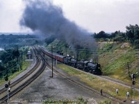 Storming through Hamilton Junction, CPR 5118 and 5214 take charge of an NRHS Buffalo Chapter excursion heading up the Goderich Sub to Guelph Junction, before speeding east down the Galt Sub to Streetsville Jct.  These two locomotives are just the first of six pressed into service for excursionists on this day, with CPR 1098, and 1092 handling the train from Streetsville to Orangeville and Fraxa, and CPR 2214, and 2332 taking the train from Streetsville back to Hamilton.  <br><br>Note the new searchlight signals on the Oakville Sub and CN's "cowpath."  Less than a year old, CN upgraded the plant around <a href=https://www.railpictures.ca/?attachment_id=60036>Bayview Junction</a> and Hamilton Junction with Centralized Traffic Control in late 1958, plus trackage through Hamilton to <a href=https://www.railpictures.ca/?attachment_id=54400>N&NW Junction,</a> where the N&NW spur and the Hagersville Sub branched off from the Grimsby Sub.  The whole operation was controlled from Hamilton's <a href=https://www.railpictures.ca/?attachment_id=38517>James Street station.</a>  The concrete base of the old <a href=http://www.cnr-in-ontario.com/Thumbs/RailwaySignaling_192710_0375-01.jpg>Hamilton Junction tower</a> remains to the left of the crossovers in the distance.  The <a href=https://archive.org/details/sim_railway-age_1958-10-20_145_16/page/n29/mode/2up>October 1958 issue of Railway Age, volume 145, issue 16,</a> features an article on the recently completed upgrades on pages 26 - 29.  <br><br>More shots of this well-documented excursion:<br><a href=https://www.railpictures.ca/?attachment_id=33872>Rounding the wye at Streetsville; John Wagner</a><br><a href=https://www.railpictures.ca/?attachment_id=28108>Northbound at Cataract (Approach)</a><br><a href=https://www.railpictures.ca/?attachment_id=44202>Northbound at Cataract (Going away)</a><br><a href=https://www.railpictures.ca/?attachment_id=36987>North of Cataract</a><br><a href=https://www.railpictures.ca/?attachment_id=47339>Pausing at Orangeville</a><br><a href=https://www.railpictures.ca/?attachment_id=28583>Taking on water at Orangeville</a><br><a href=https://www.railpictures.ca/?attachment_id=50062>Headed to Fraxa</a><br><a href=https://www.railpictures.ca/?attachment_id=13014>Waiting at Streetsville</a><br><br>More of Hamilton Jct. from the hill:<br><a href=https://www.railpictures.ca/?attachment_id=12998>TH&B 1977; Steve Danko</a><br><a href=https://www.railpictures.ca/?attachment_id=24399>CP 2016; Jacob Patterson</a>  <br><br><i>Original Photographer Unknown, Jacob Patterson Collection Slide.</i>