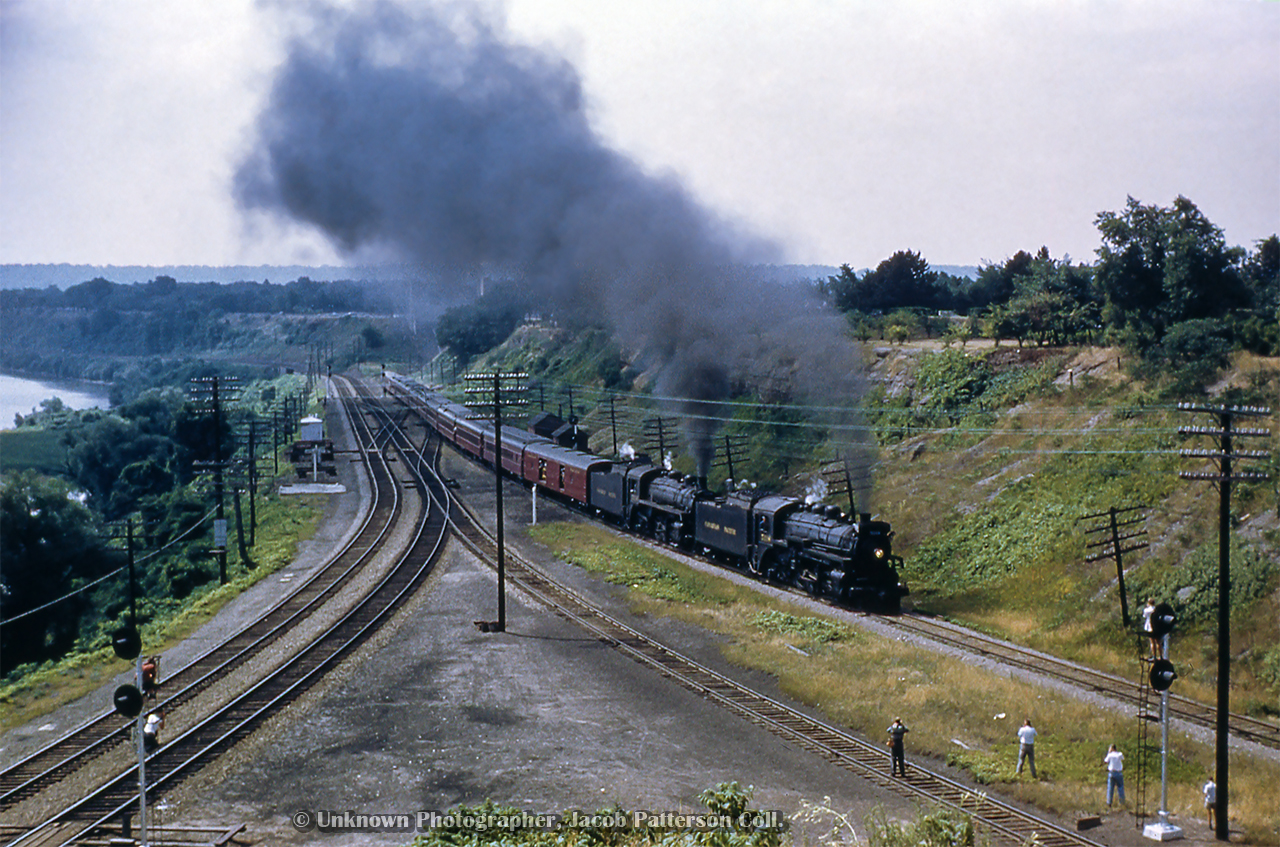 Storming through Hamilton Junction, CPR 5118 and 5214 take charge of an NRHS Buffalo Chapter excursion heading up the Goderich Sub to Guelph Junction, before speeding east down the Galt Sub to Streetsville Jct.  These two locomotives are just the first of six pressed into service for excursionists on this day, with CPR 1098, and 1092 handling the train from Streetsville to Orangeville/Fraxa, and CPR 2214, and 2332 taking the train from Streetsville back to Hamilton.

Note the new searchlight signals on the Oakville Sub and CN's "cowpath."  Less than a year old, CN upgraded the plant around Bayview Junction and Hamilton Junction with Centralized Traffic Control in late 1958, plus trackage through Hamilton to N&NW Junction, where the N&NW spur and the Hagersville Sub branched off from the Grimsby Sub.  The whole operation was controlled from Hamilton's James Street station.  The concrete base of the old