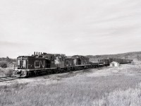 Southward from the north end of CN’s Athabasca subdivision at Athabasca, the line followed Tawatinaw Creek to start the trip back to Calder yard in Edmonton.  On Tuesday 1978-09-19 at 1649 MDT, CN 1383 + 1380 + 1007 trundled by the Station Name Sign and maintenance-of-way shelter at Tawatinaw.