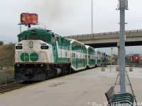 After stepping off our afternoon GO train home (#281, the "Bramalea Flip" from Union to Brampton), GO Transit F59PH 521 on the rear accelerates its L8 consist out of Bramalea GO Station, dipping under Steeles Avenue underpass just as a convenient eastbound CN freight lead by C44-9W units 2609 and 2660 approaches in the distance (about to startle the pigeons roosting on the overpass). By the end of the platform, the F59 was usually moving at a pretty good clip to get the train up to speed for the climb up the Halton Sub through <a href=http://www.railpictures.ca/?attachment_id=2143><b>Peel</b></a> and <a href=http://www.railpictures.ca/?attachment_id=9714><b>Brampton East</b></a> interlockings and into <a href=http://www.railpictures.ca/?attachment_id=852><b>downtown Brampton</b></a> for its final stop.<br><br>This particular consist kept itself busy all day: it would enter service in the morning as southbound train #830 on the Richmond Hill line, do a stint on the Lakeshore line as train #908 from Burlington to Oshawa, deadhead to Bramalea, then spend all afternoon running the afternoon Bramalea trains back and forth from Toronto (#<a href=http://www.railpictures.ca/?attachment_id=59199><b>251</b></a>, <a href=https://www.railpictures.ca/?attachment_id=18561><b>254</b></a>, 257, <a href=https://www.railpictures.ca/?attachment_id=54428><b>260</b></a>, <a href=https://www.railpictures.ca/?attachment_id=49536><b>263</b></a>, 266) before a final run as #281 punching through into downtown Brampton, and <a href=https://www.railpictures.ca/?attachment_id=32906><b>deadheading</b></a> back to Toronto for its last assignment as #864 up the Stouffville line.