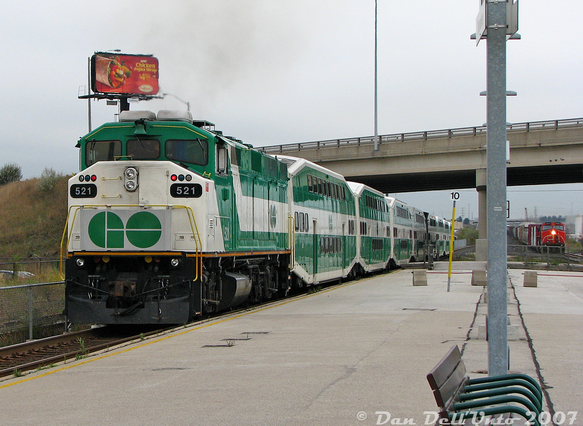 After stepping off our afternoon GO train home (#281, the "Bramalea Flip" from Union to Brampton), GO Transit F59PH 521 on the rear accelerates its L8 consist out of Bramalea GO Station, dipping under Steeles Avenue underpass just as a convenient eastbound CN freight lead by C44-9W units 2609 and 2660 approaches in the distance (about to startle the pigeons roosting on the overpass). By the end of the platform, the F59 was usually moving at a pretty good clip to get the train up to speed for the climb up the Halton Sub through Peel and Brampton East interlockings and into downtown Brampton for its final stop.This particular consist kept itself busy all day: it would enter service in the morning as southbound train #830 on the Richmond Hill line, do a stint on the Lakeshore line as train #908 from Burlington to Oshawa, deadhead to Bramalea, then spend all afternoon running the afternoon Bramalea trains back and forth from Toronto (#251, 254, 257, 260, 263, 266) before a final run punching through into downtown Brampton, and deadheading back to Toronto for its last assignment as #864 up the Stouffville line.