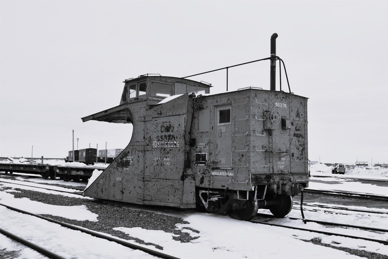 1956 or 2026?  
The March 1930 built single track snowplow sits in the barren HBR yard at Churchill, MB among standard flat cars, box cars, and TOFC loads that could easily place this photo in the mid-1950's. 
The big give-away as to the timeframe of the pic is the modern Bobcat loader at the right of the frame. 
HBRY 55376 (ex-CN 55376) single track snowplow is tied down in front of the station at Churchill, MB Mile 509.8 HBR Herchmer Sub. on April 30, 2026. 
At 96 years old, this classic snowplow soldiers on!