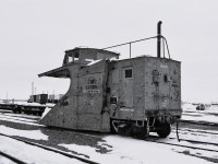 <b> 1956 or 2026? </b> <br>
The March 1930 built single track snowplow sits in the barren HBR yard at Churchill, MB among standard flat cars, box cars, and TOFC loads that could easily place this photo in the mid-1950's. <br>
The big give-away as to the timeframe of the pic is the modern Bobcat loader at the right of the frame. <br>
HBRY 55376 (ex-CN 55376) single track snowplow is tied down in front of the station at Churchill, MB Mile 509.8 HBR Herchmer Sub. on April 30, 2026. <br>
At 96 years old, this classic snowplow soldiers on!