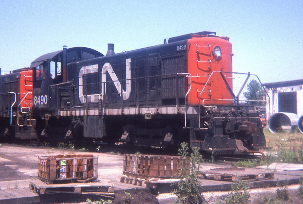 A relic from the past. CN MLW S-3 #8490 is seen past its active days languishing at the end of a storage track in London's Rectory St reclamation yard on a nice warm June day. The whole series, 8400-8498, were gone from the roster by 1975. These units were built between 1951 and 1954.