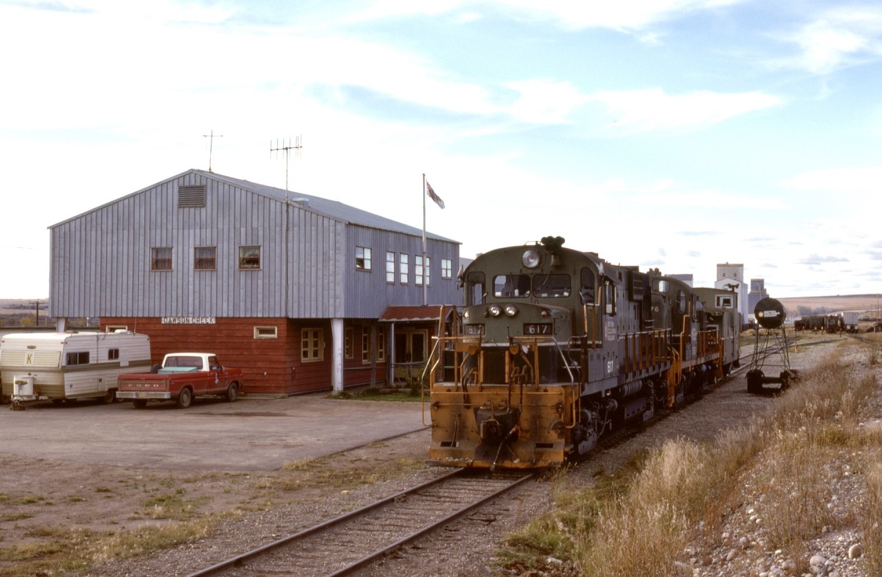 Dawson Creek was the farthest east reached by the British Columbia Railway, where it connected with Northern Alberta Railways just east of this photo.  On Wednesday 1977-09-21, a crew from Chetwynd has arrived with BCOL 617 + 576 and yarded their train, so now enjoying a lunch break at the depot.