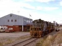 Dawson Creek was the farthest east reached by the British Columbia Railway, where it connected with Northern Alberta Railways just east of this photo.  On Wednesday 1977-09-21, a crew from Chetwynd has arrived with BCOL 617 + 576 and yarded their train, so now enjoying a lunch break at the depot.