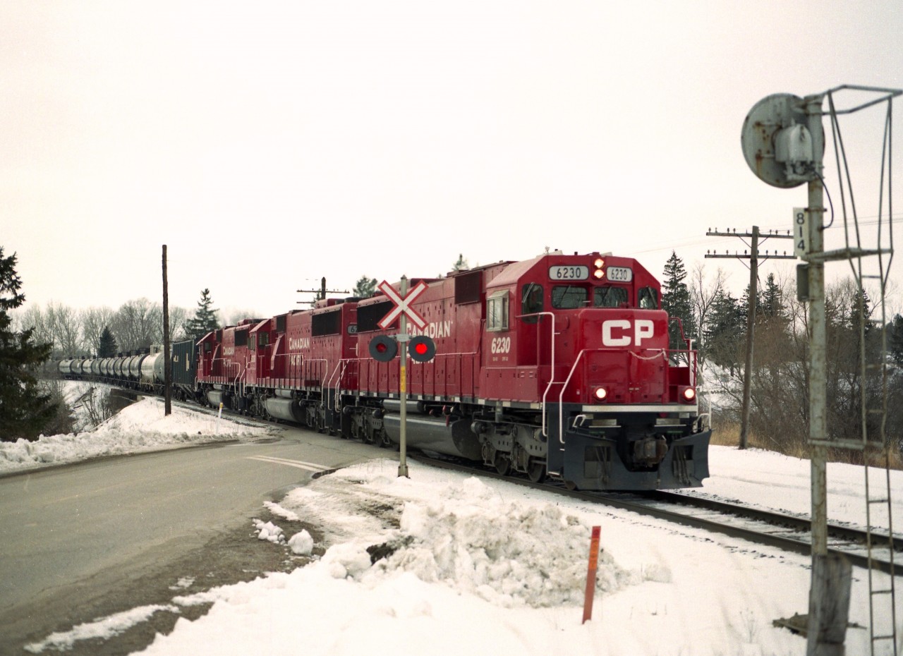 Went out for the ethanol train on a decently mild early March day and was treated with a trio of CP SD60s for power. A nice change from the usual mixture of 'anything that runs'.  This image was taken at Township Rd 6; south end of the community of Innerkip and the power is CP 6230, 6236 and 6249.
The paint looks clean; the units had recently been part of the SOO empire, now lettered for CP.