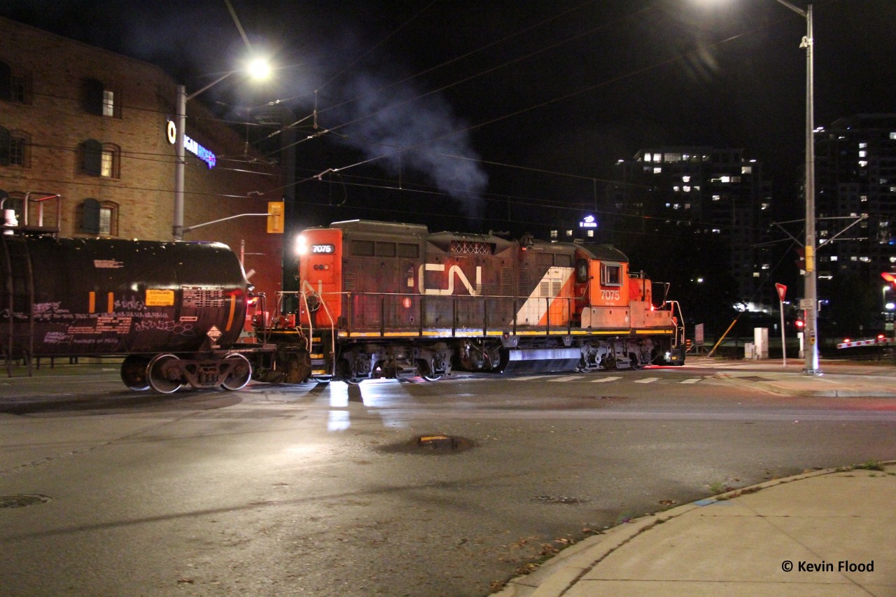 Solo CN 7075 chugs away with its train of tanks heading towards Elmira for switching out Lanxess up there. Note, WCR does switching in/around the plant and CN will do a lift/setoff and maybe other switching. Here it is pictured crossing the intersection of Erb St. and Caroline St. in Uptown Waterloo.