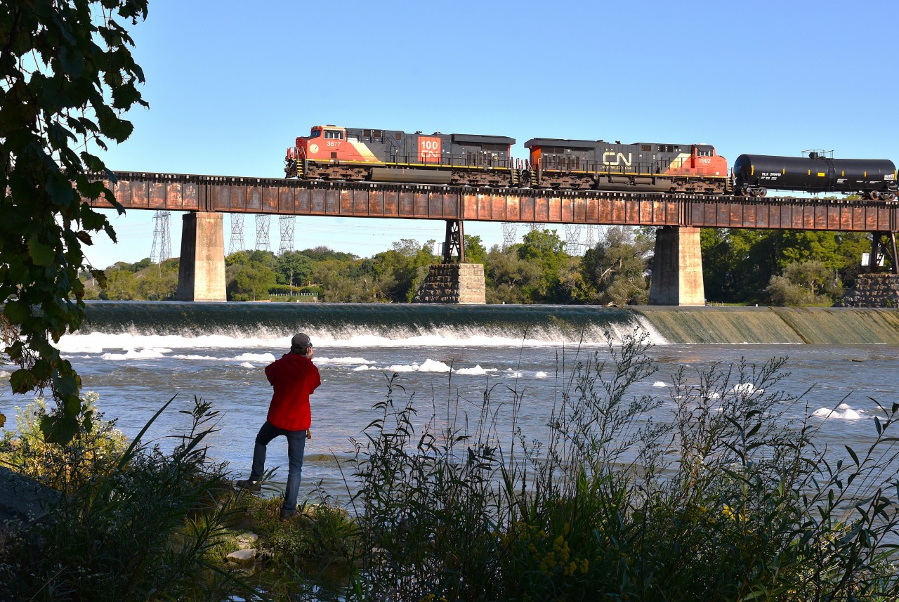 No, this photo was not staged.  I was awaiting CN's #502 with 3877 and 2902 to advance further across the Caledonia Grand River bridge when suddenly into view comes Jason (Ladder Boy) Bartlett. He had no idea I was behind him. Snapped the photo anyway and decided he actually complimented the scene.  Well, there is a first for everything. :o)