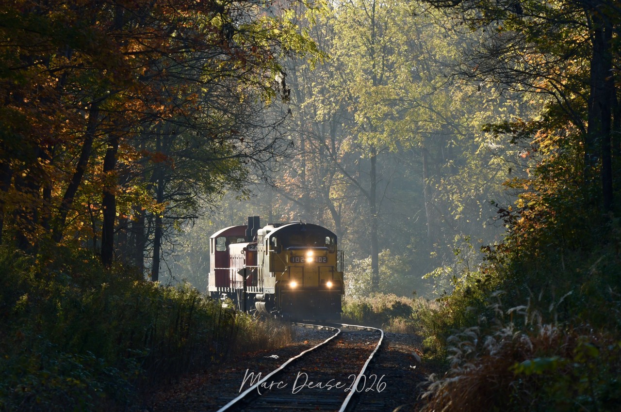 A beautiful cool and crisp fall morning with a little bit of fog caught my attention as I crossed the tracks at Benson Street in Ingersoll. The fast rising sun was not in my favour as the fog was burins off fast. After a short wait the St. Thomas job showed up with OSR 102 leading and 1244 trailing, still an interesting photo I think.