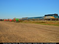 Fall colors don't only come from the leaves on the trees.  Growing up in a farming family the colors of Fall also came from the red, orange, and green wagon loads of yellow soya beans and golden field corn, not to mention the Ford blue, John Deere green, IH red, and Allis orange on the tractors pulling them.  Here VIA train #72 approaches Stoney Point as it passes a partially harvested field of soya beans showing off the fall colors of farming......