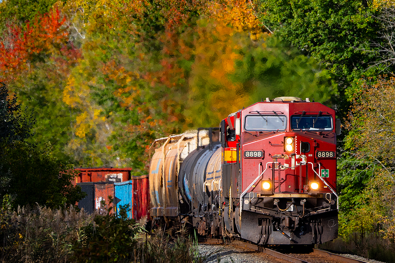Autumn is on display as CP 8898 leads an eastbound through Trenton with a cheerful crew on board.