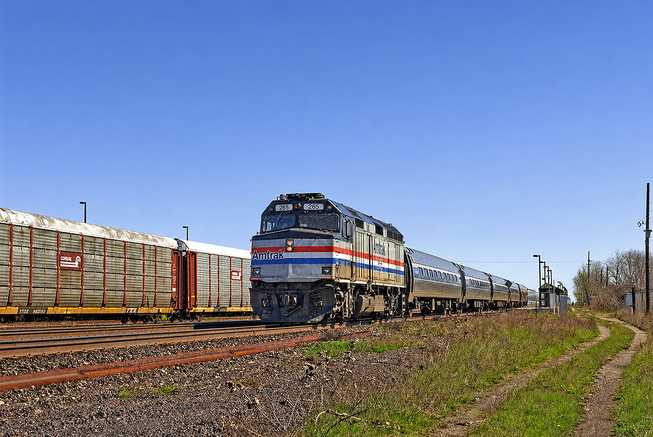 Amtrak F40PH #265, operating as VIA train #97 (The Maple Leaf), departs Aldershot for Niagara Falls and ultimately NYC. It's amazing to look back and see how small and seemingly insignificant Aldershot station was back then compared to today- the scene almost looks forlorn despite the autoracks in the yard.