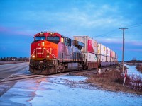 As the sun rises during the early spring, CN 2871 is leading their intermodel train into Eastern Manitoba