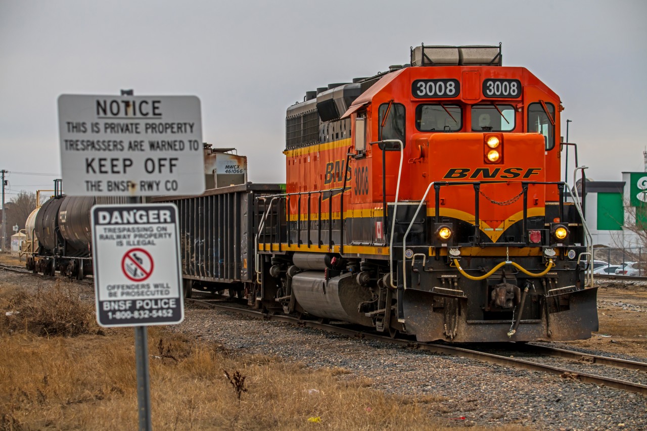 BNSF 3008 leading their small little freight train through Winnipeg's St. James neighborhood. They will leaving cars for CPKC to pick up.