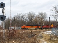 Perfect 'permacrud' type of day. I decided to check out the former C&O / CSX station grounds. So much change, since I was here 20 years before. Standing on the southern portion of the wye, last used back when these two roads exchanged traffic, this auto rack train snuck up on me. Led by a wonderfully coloured BNSF leader, I believe this was train 235.
<br>
<br>
NOTE: Both north and south signals,  although unused, still stand protecting where the diamond once was between the CP and CSX. Of course, mounds of dirt were piled on either side of this once busy C&O Sub. No. 2. The little Chatham depot once stood to the left, but out of frame. The red brick platform was still in place then, as was most sidings in the CP yard. 