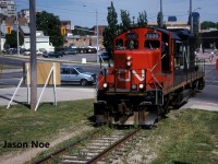 The CN 15:30 Kitchener Job with GP9RM 7030 makes a mid-afternoon appearance in downtown Waterloo, having just crossed Caroline and Erb Streets. The crew was heading to the town of Elmira, Ontario on the Waterloo Spur light power. Often during the month of July in the 90’s, with the Budd Plant in Kitchener slowing production for summer shut down, they didn’t require CN service daily, so the 15:30 Job would head to Elmira earlier in the afternoon rather than later in the evening.