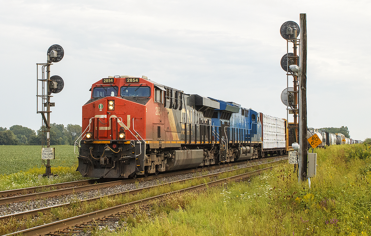 After seeing the Anniversary train along Sarnia's waterfront,  I was out and about. To end the day, I shot this train when it came to a stop,  at Camlachie Road for clearance into Sarnia.  Thankfully, the rain had stopped and the sun hadn't fully come out again as the train is now entering Sarnia at Blackwell Road. 


As it splits the signals,  of note are the two signs on either side showing what appear to be radio frequencies to communicate through.