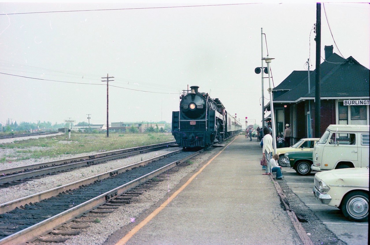 On a warm morning during the summer of 1976, CN 6060 slows to a stop at the Burlington station. During this time period, CN ran weekend excursions Toronto to Niagara Falls and return, with stops at Oakville, Burlington and Hamilton.
The price was low and the experience was thrilling. Two different occasions I took my Father on a trip, and we stood in the baggage car both times after leaving Merritton, just to catch the sights and sounds of climbing up the grade to Clifton.
Good times.