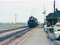 On a warm morning during the summer of 1976, CN 6060 slows to a stop at the Burlington station. During this time period, CN ran weekend excursions Toronto to Niagara Falls and return, with stops at Oakville, Burlington and Hamilton.
The price was low and the experience was thrilling. Two different occasions I took my Father on a trip, and we stood in the baggage car both times after leaving Merritton, just to catch the sights and sounds of climbing up the grade to Clifton.
Good times.