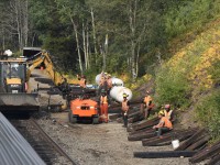 <b> If you want to run trains, you have to do maintenance </b> <br>
The crew of CN Construction Gang CW55 takes a break to conduct a roll-by inspection, and wave at the passengers aboard VIA 005 The Skeena as it rolls past their worksite at CN Wynd, AB Mile 2.57 Albreda Sub. just a few miles west of Jasper. <br>
A nice day to be retired and riding a train. Also a nice day to be working on the railroad.