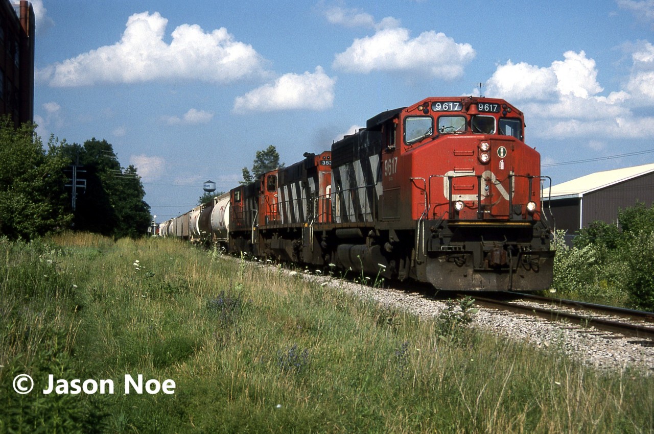 CN train 431 is pictured departing Kitchener, Ontario on the Guelph Subdivision for Stratford having just crossed Park and Strange Streets. Powering the train is GP40-2L(W) 9617 as well as M-420(W)’s 3531 and 3519.
