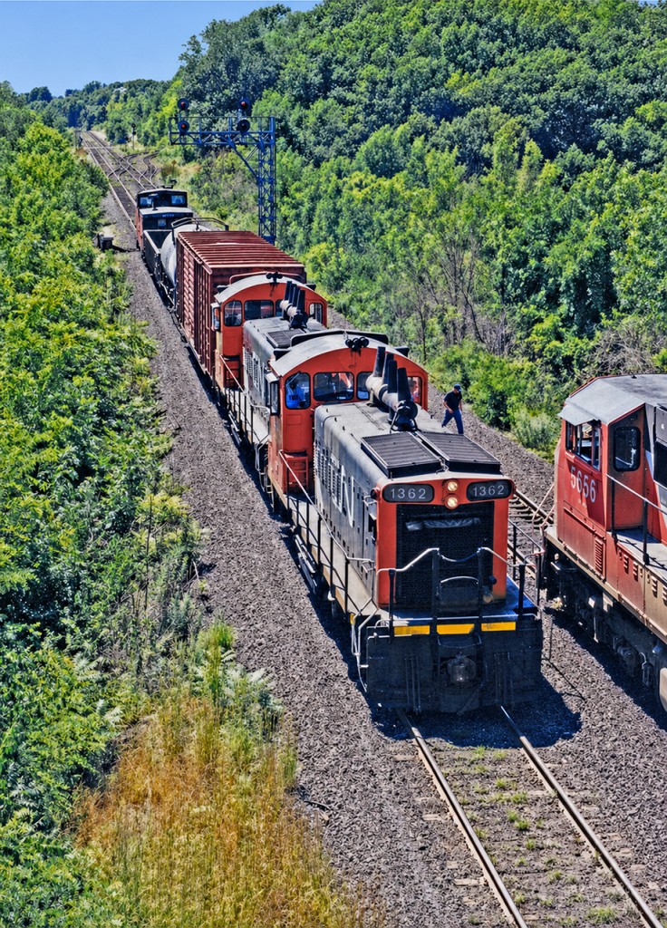 CN SW1200RS #1362 leads another sister with a short transfer train (including a van!) through Bayview Junction on a hot early afternoon in August 1997. SD75I 5656 can be seen heading a manifest train towards the Dundas Subdivision. The 1362 has long since left CN's roster, and the 5656 has been rebuilt into SD75IACC 8321. I always liked the SW1200s and didn't think they'd be gone as soon as they were, especially given how long the GP9RMs have soldiered on. The lighting here wasn't ideal which I knew at the time, as I was there to capture VIA train 73 from the other side of the bridge. This short train happened to appear, so I took what I got as a bonus regardless of the lighting. More examples of power I wish I'd have chased down and photographed now.