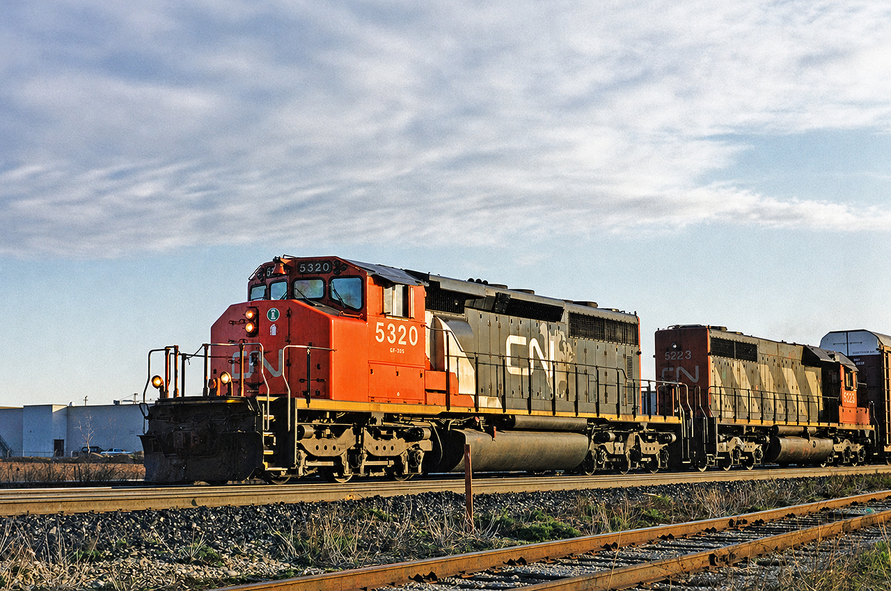 CN SD40-2W #5320 leads SD40 #5223 on a train full of autoracks from the Oakville Ford plant westbound through Burlington on a calm April morning. I believe the 5320 is still active on CN's roster, but the classic SD40 5223 has long been scrapped and met its end at Larry's Truck and Electric.