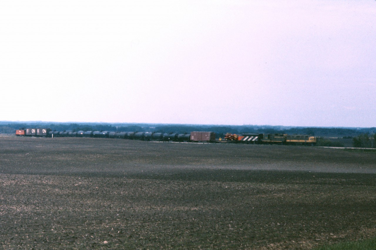 With plenty of power for a 15 car train and 50 mph track, this freight should make good time on its eastward trip across the Prairie North Line (PNL). It is likely No. 884 which was scheduled to leave St. Paul Jct (Edmonton) at 0805 daily except Sunday in the early 1970s according to an employee time table in my collection. The same document shows a meet with Railiner No. 691 at Lavoy (one siding east of Vegreville) at 1015. The Vegreville sub carded two eastward and two westward freights per day as well the North Battleford "Budd cars" in the early '70s. Power is an F7A/GP9/F7A combo with two of those units still in the classic green and yellow, 10 years after the adoption of the "CN noodle".