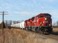 On a fine, nearly Spring morning...another SD70ACu rebuilt engine in CP 7006, leading with a second unidentified unit around the bend approaching Arkwood Road crossing.
<br>
<br>
The train stands out against the brownish landscape, as the sun highlights the still fairly fresh looking paint on 7006.
