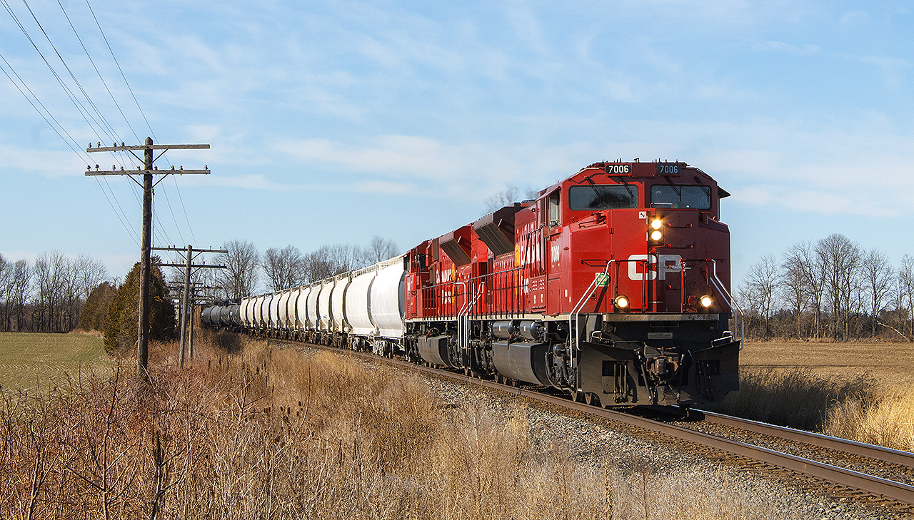 On a fine, nearly Spring morning...another SD70ACu rebuilt engine in CP 7006, leading with a second unidentified unit around the bend approaching Arkwood Road crossing.


The train stands out against the brownish landscape, as the sun highlights the still fairly fresh looking paint on 7006.
