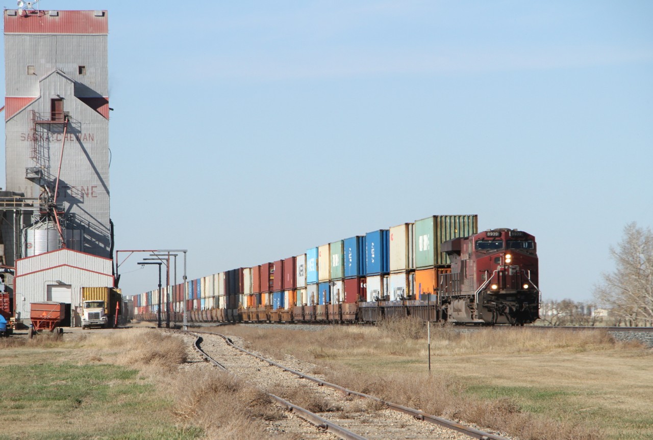 Leading a consist of double stacked shipping containers, CP 8939, a GE ES44AC, eastbound through Milestone Saskatchewan.