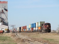 Leading a consist of double stacked shipping containers, CP 8939, a GE ES44AC, eastbound through Milestone Saskatchewan.
