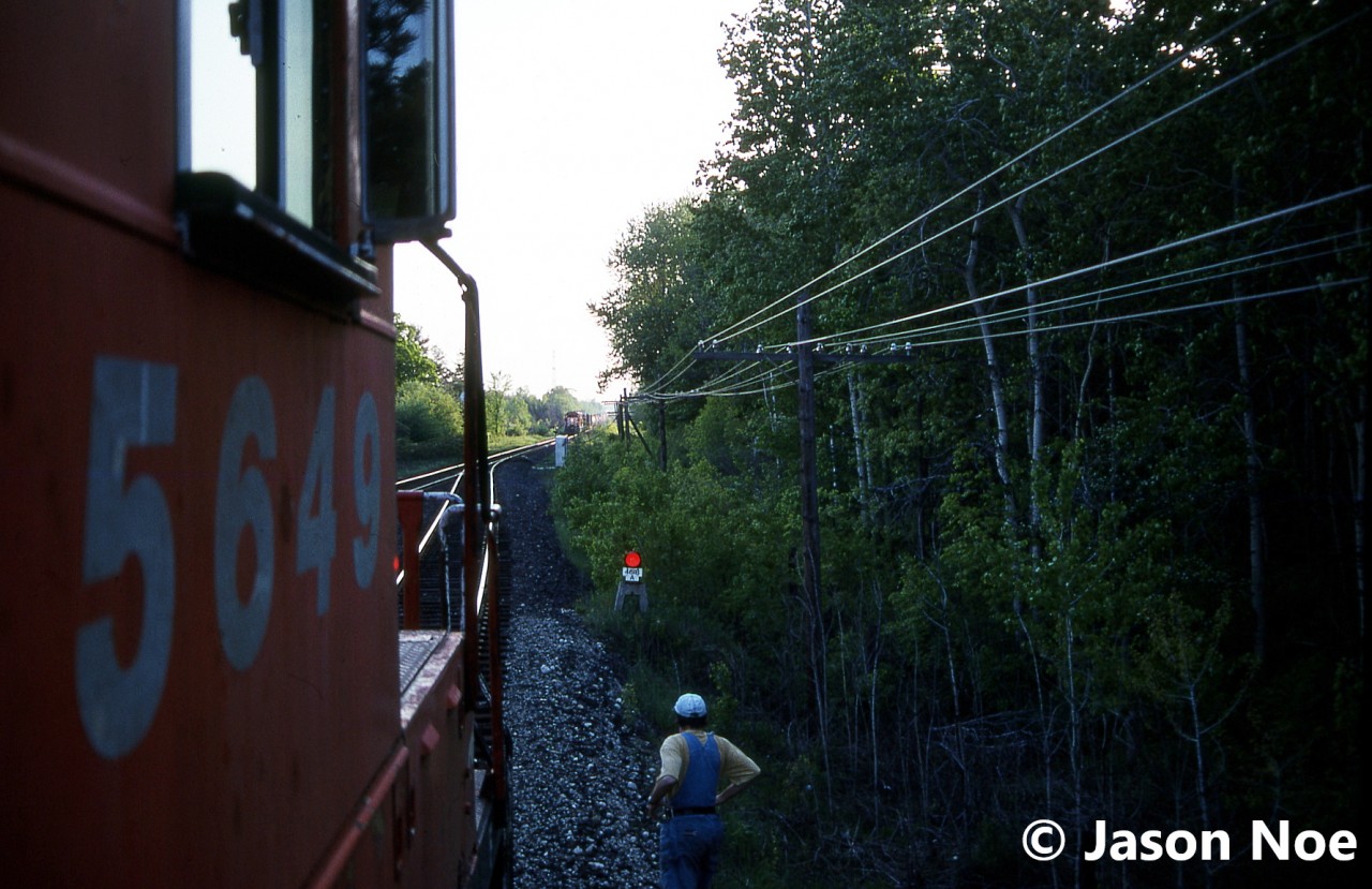 A view from CP SD40-2 5649 as train 737 waits at the west siding switch Puslinch for a meet with an approaching eastbound on the Galt Subdivision. At the time, 737 was a dedicated auto train and on this evening the friendly crew had invited a friend and I along for a cab ride to the top of Orrs Lake hill from Puslinch. The consist included SD40-2’s 5649 and 5682.